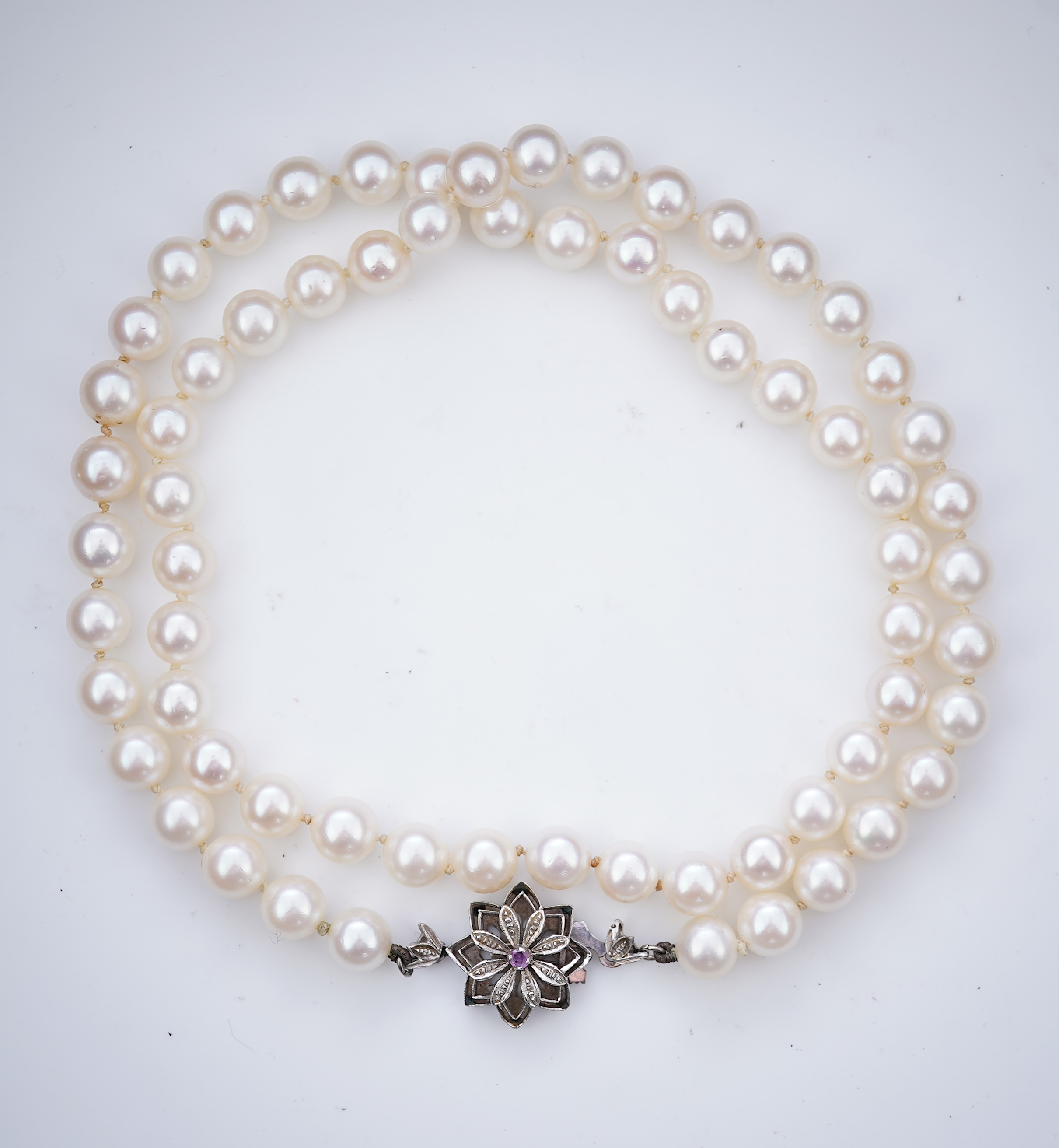 A cultured pearl necklace and pair of mabé cultured pearl ear clips